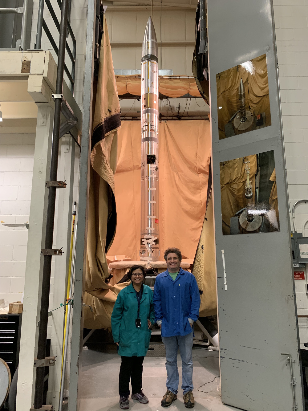 Nguyen and Zemcov standing in front of the CIBER-2 payload, integrated into the Black Brant IX rocket at Wallops Flight Facility, Virginia.